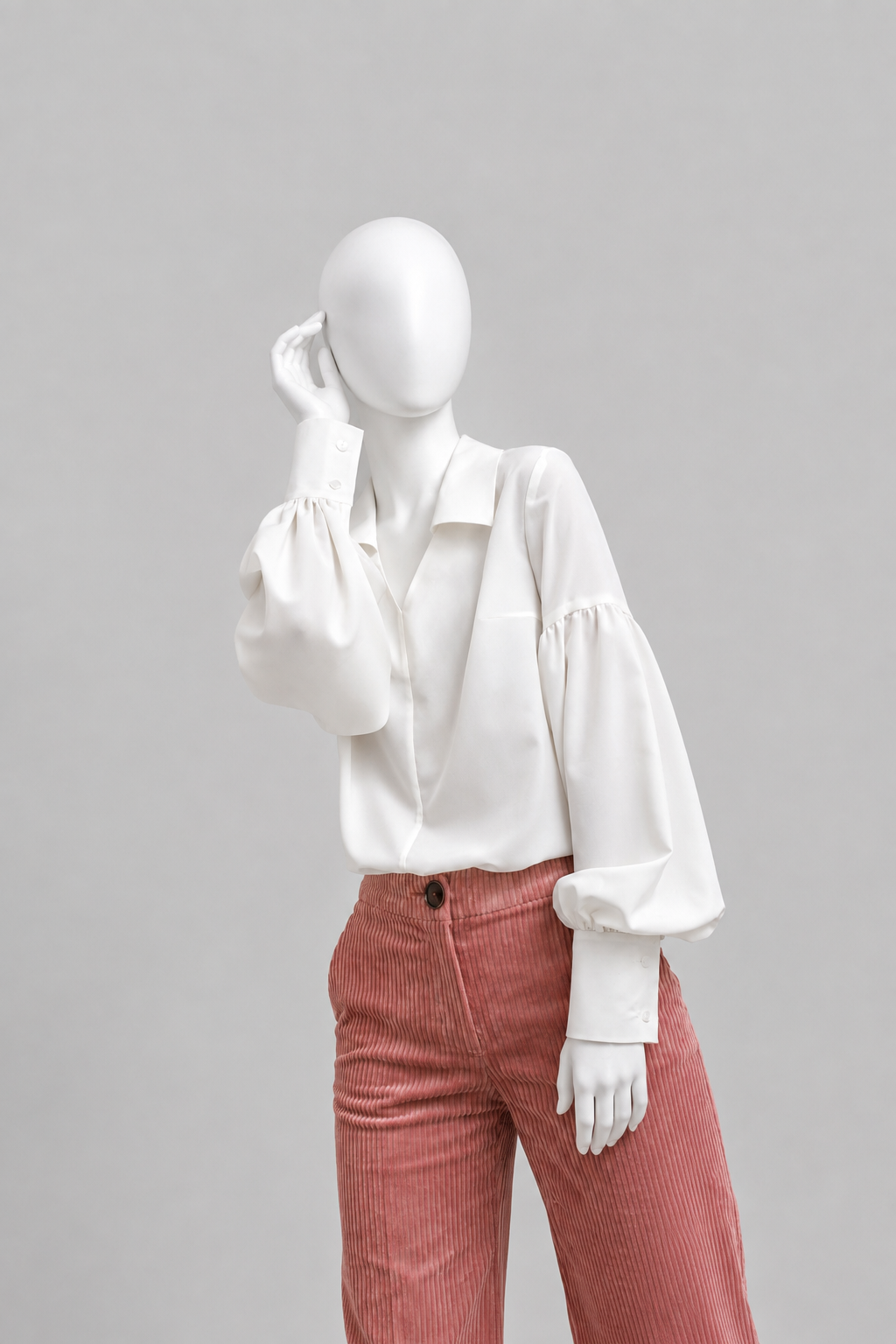 Voluminous blouse of A-silhouette hits below the hip line. G